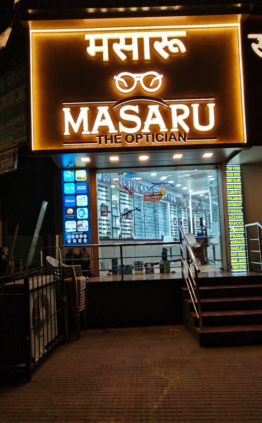 The lit Masaru – The Optician shop front on S.V. Road, Bandra West